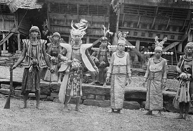 Pria berpakaian militer dan dua wanita berpakaian upacara di Bawodobara