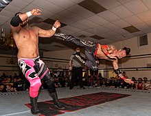 Arquette (pictured, right, with Ethan Page, left, in 2019) later returned to the ring. David Arquette Alpha1 2019 kick.jpg