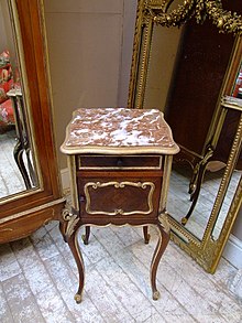 A table given an antiqued appearance resembling Florentine-style woodwork, with gold paint applied to carved details to resemble gilding. Distressing table gild.jpg