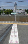 Markings on the platform at Hitomarumae Station showing the Japan Standard Time meridian