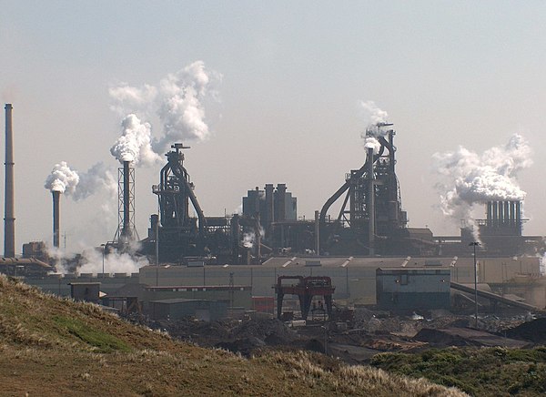 Integrated steel mill in the Netherlands. The two massive towers are blast furnaces.
