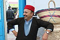 * Nomination This man wears a kadroun which is a traditionnal long shirt made from wool. On the head, he wears kabous which is a traditional Tunisian hat. Next to him there is a Tunisian bag called Kofa. By User:Sami Mlouhi --Touzrimounir 19:50, 22 December 2015 (UTC) * Promotion Good quality. --Vikoula5 11:13, 23 December 2015 (UTC)