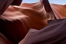 Lower Antelope Canyon was carved out of the surrounding sandstone by both mechanical weathering and chemical weathering. Wind, sand, and water from flash flooding are the primary weathering agents. Lower antelope 3 md.jpg