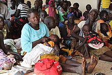 South Sudanese refugees waiting at a health center at the Maaji refugee settlement in Adjumani district, in Uganda.