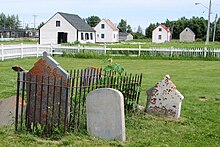 Centennial Park - foreground: historic cemetery; background (from left to right): blacksmith shop, McLeod House, Sackabuckiskum House, Powder magazine. Moose Factory Centennial Park.JPG