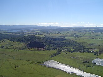 Mt Quincan, viewed from the southeast, showing the southern quarry with the main scoria cone behind it and the low-lying crater to the east. Mt Quincan aerial view.jpg