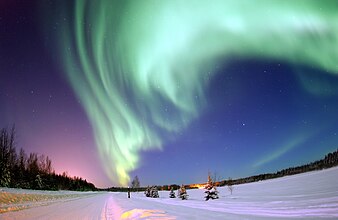 Aurora corealis shines above Bear Lake near Eielson Air Force Base, Alaska