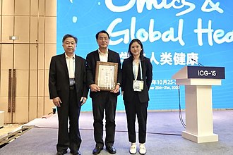 Zhang Yongzhen in Wuhan collecting the 2020 ICG-15 GigaScience Prize for Outstanding Data Sharing during the COVID-19 Pandemic from BGI's Yang Huanming. Professor Zhang Yongzhen winning 2020 ICG-15 GigaScience Prize for Outstanding Data Sharing during the COVID-19 Pandemic.jpg