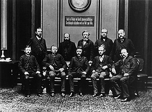 SPD members in Reichstag 1889, (sitting from left to right: Georg Schumacher, Friedrich Harm, August Bebel, Heinrich Meister and Karl Frohme. Standing: Johann Heinrich Wilhelm Dietz, August Kuhn, Wilhelm Liebknecht, Karl Grillenberger, and Paul Singer) Reichstagsfraktion1889.jpg