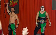 Stupefied (left) and Player Uno (right) as Super Smash Brothers with the Alpha-1 Tag championship belts in 2011 SSB A1 tag champ.jpg