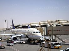 A Saudia Airbus A320 at the gate.