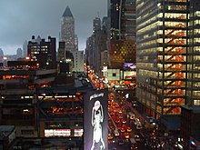 Eighth Avenue, looking northward (Uptown), in the rain; most streets and avenues in Manhattan's grid plan incorporate a one-way traffic configuration.