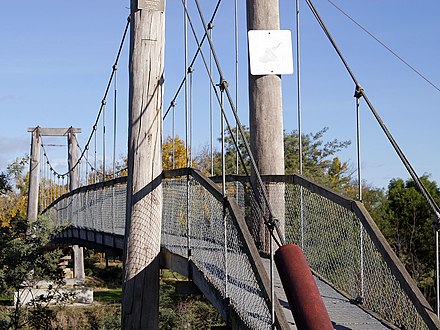 A suspension bridge can be made out of simple materials such as wood and common wire rope.