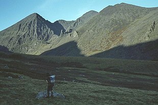 Looking into the deep Eagle's Nest corrie from the Hag's Glen.  The Nest is surrounded by Carrauntoohil (left), The Bones (back, centre), and Beenkeragh (right); Knockbrinea is at the far right.  The Hag's Tooth is visible at the entrance to the corrie, as is the Hag's Tooth Ridge up to the summit of Beenkeragh.