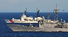USS Vandegrift (FFG 48) and USCGC Mellon (WHEC-717) cruising side by side in the Java Sea on May 28, 2010