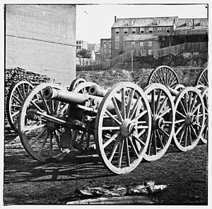 Photo shows several 6-pounder guns pushed together at an unknown location.