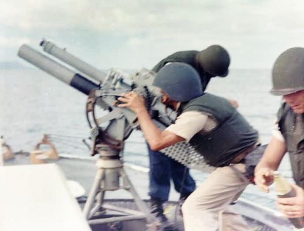 A gun crew on board USCGC Point Comfort (WPB-82317) firing an 81mm mortar during the bombardment of a suspected Viet Cong staging area one mile behind