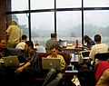 Wikimaniacs take shelter in the Open Space as a brief but torrential rain pours outside.