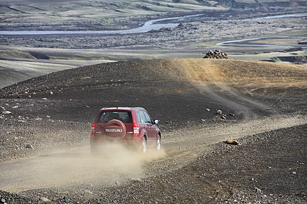 SUV driving on a gravel road in the interior of Iceland