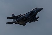 An F-15E Strike Eagle, tail number 01-2003, taking off from RAF Lakenheath in England. The aircraft is assigned to the 494th Fighter Squadron.