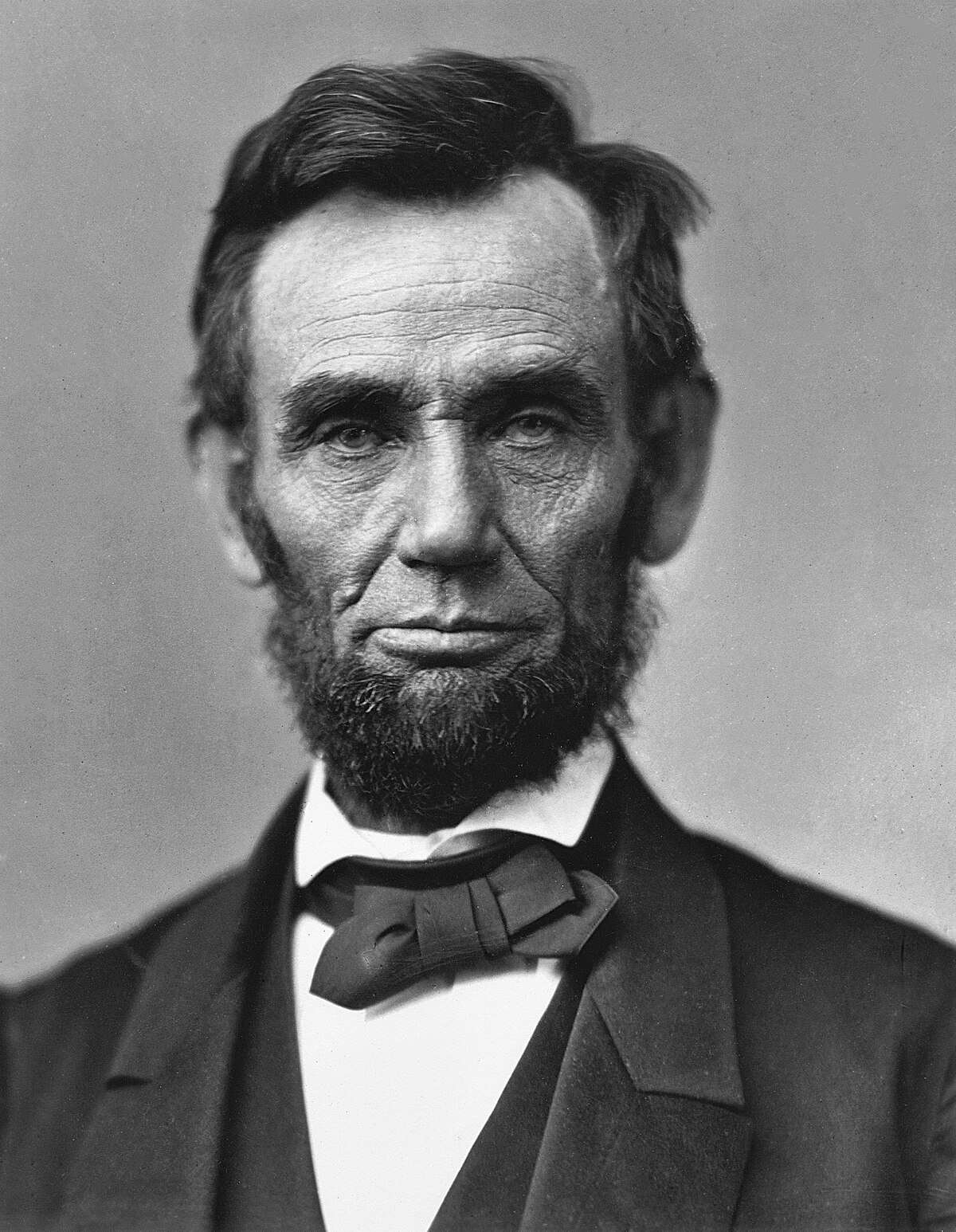 An iconic photograph of a bearded Abraham Lincoln showing his head and shoulders.