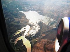 Aerial view of a large reservoire surrounded by fields
