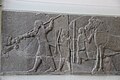 Alabaster Bas-relief of Lion hunt; Ashurbanipal thrusts spear into a leaping lion. Elamite attendant assists him. From the North Palace at Nineveh, Iraq, 7th C. BC.jpg