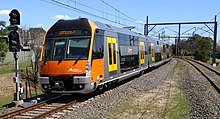 A Sydney Trains B set with an upper and lower deck B set departing Panania 20180919 01 (Nimed).jpg