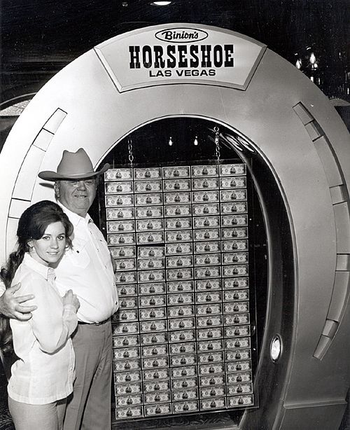 Benny Binion with his youngest daughter Becky (eventual owner of Binion's Horseshoe) in front of the famous $1 million display (c. 1969).