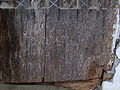 Inscripţie în latină, aflată în partea dreaptă-jos a portalului