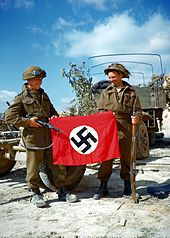 Canadian soldiers with a captured Nazi flag Canadiannaziflag1944.jpg