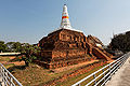 At Chedi Phra Pathon in Nakhon Pathom, a newer white prang sits atop an ancient Dvaravati stupa base.