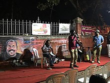 Scene from a concert in honor of Kalabhavan Mani at Manaveeyam Veedhi in March, 2019. A wall-painting of Mani is also seen in the background. Concert in honor of Kalabhavan Mani at Manaveeyam Veedhi.jpg