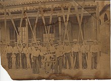 Crew of HMS Daring circa 1885, and their mascot, a rooster Crew HMS Daring (1874-89).jpg