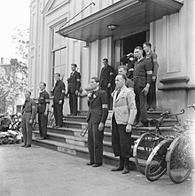 Men of the Binnenlandse Strijdkrachten, armed with rifles and STENs, form a guard of honor for a visit by Prince Bernhard, April 1945. De Binnenlandse Strijdkrachten, bewapend met geweren en stenguns, vormen een ere, Bestanddeelnr 900-2491.jpg