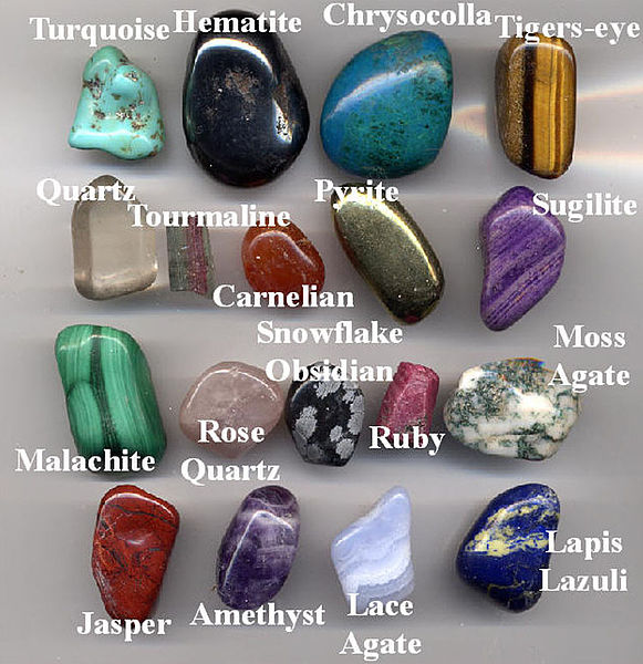 A collection of gemstone pebbles made by tumbling the rough stones, except the ruby and tourmaline, with abrasive grit inside a rotating barrel. The l