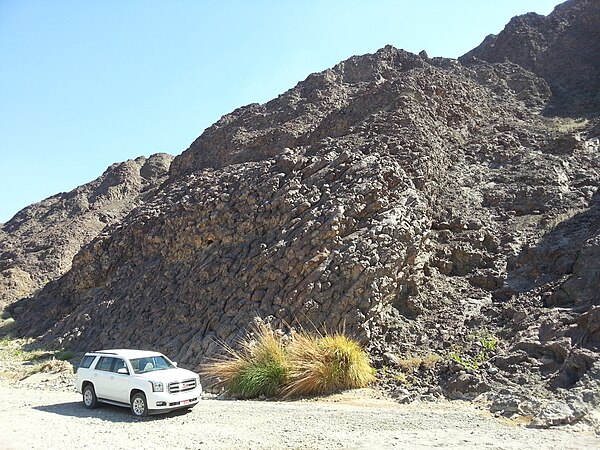 Pillow basalts at Wadi Jizz, which is part of the Semail Ophiolite sequence. These were named the Geotimes Pillow Lavas after a photo of them was publ