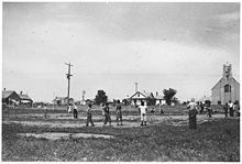 Group of Indian children playing baseball, village in background. - NARA - 285572.jpg