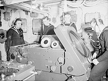 High Angle Control System fire control computer (table) Mk IV, aboard HMS Duke of York. The Deflection operator is seated in front of the deflection screen. The range plot operator stands directly opposite. HACS MK IV Table on board HMS Duke of York.jpg