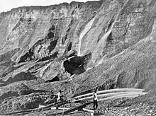 Gold miners excavate an eroded bluff with jets of water at a placer mine in Dutch Flat, California sometime between 1857 and 1870. Hydraulic mining in Dutch Flat, California, between 1857 and 1870.jpg