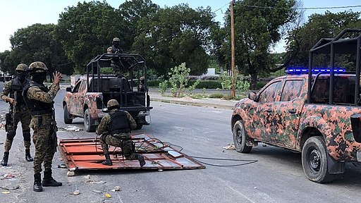 Haiti's National Police guard remove makeshift barricades made of steel fences and tree branches protesters placed to block the National Palace entrance, Oct. 31, 2019. (Photo: Matiado Vilme / VOA -- Public Domain)