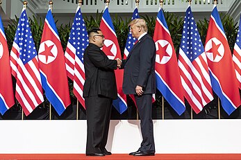 Donald Trump shaking hands with the supreme leader of North Korea on June 12, 2018, the first U.S. president to do so. Kim and Trump shaking hands at the red carpet during the DPRK-USA Singapore Summit.jpg