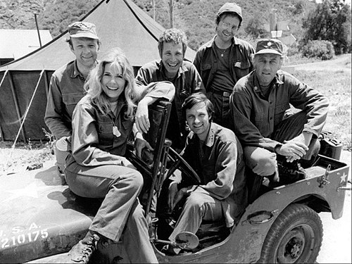 Publicity photo of the cast of M*A*S*H shot just prior to the production of Season 2, 1974 (clockwise from left): Loretta Swit, Larry Linville, Wayne Rogers, Gary Burghoff, McLean Stevenson, and Alan Alda