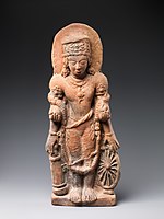 A statue of Vishnu Caturanana ("Four-Armed"), using the attributes of Vāsudeva, with the addition of an aureole around the head (5th century CE).[71]