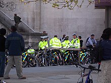 Metropolitan Police officers with their cycles awaiting the start of Critical Mass London, April 2006. Metropolitan Police officers at Critical Mass London, April 2006.jpg