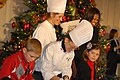 Michelle Obama and White House chefs help military children decorate cookies, 2011.jpg