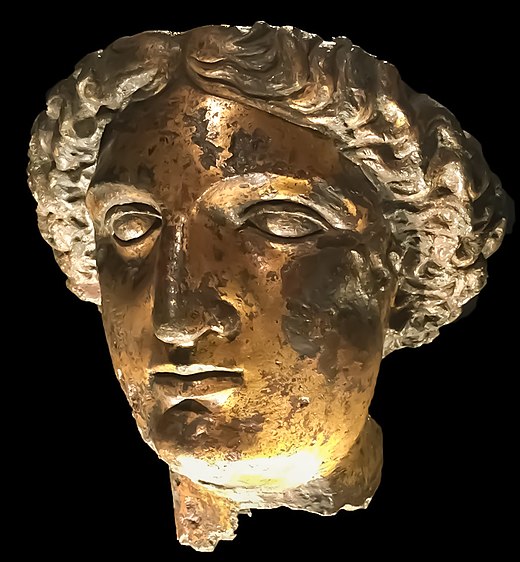 The gilt bronze head of a woman in a Roman style.