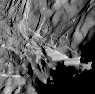 Close-up view of Verona Rupes, a 20 km high fault scarp on Miranda, a moon of Uranus. Miranda scarp.jpg