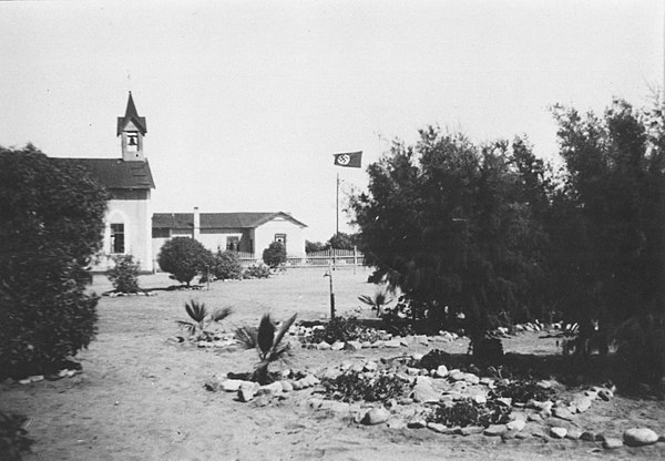 Mission Church and building of the Rheinische Missionsgesellschaft in 1938 near a visible Nazi flag.