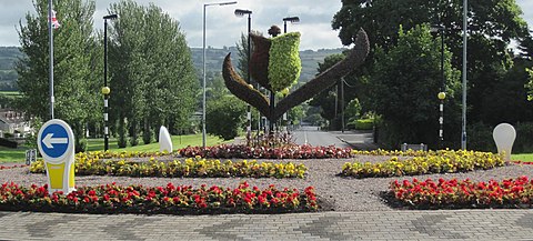 Floral sculpture on a roundabout in the borough showing a 3D representation of Newtownabbey Borough Council's logo